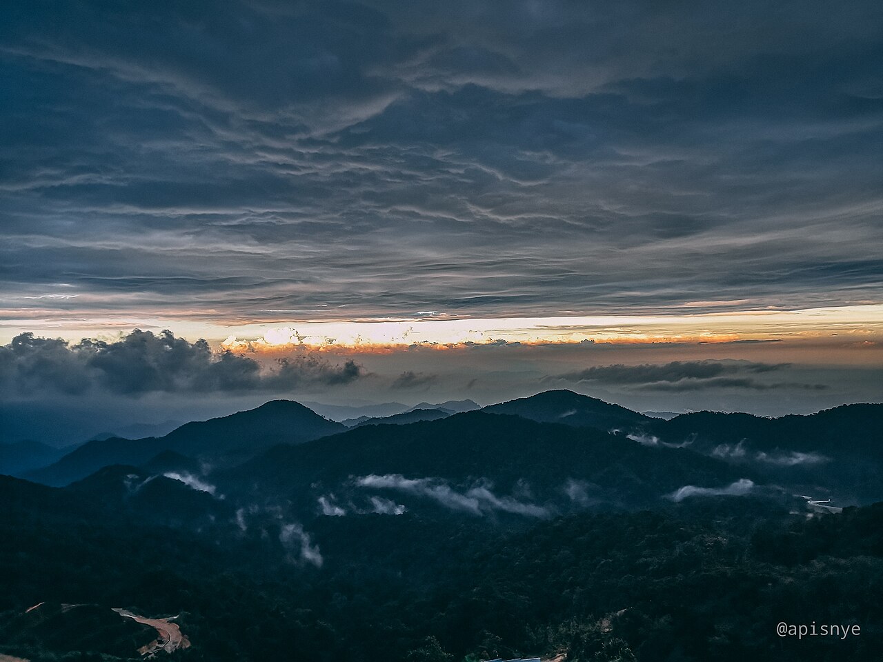 Cloud sitting over the forested valley below Genting Highlands at sunrise